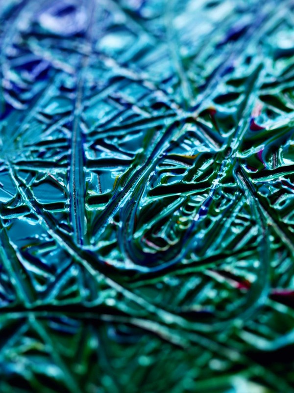 Detailed close-up of colorful abstract wax texture with intricate patterns.